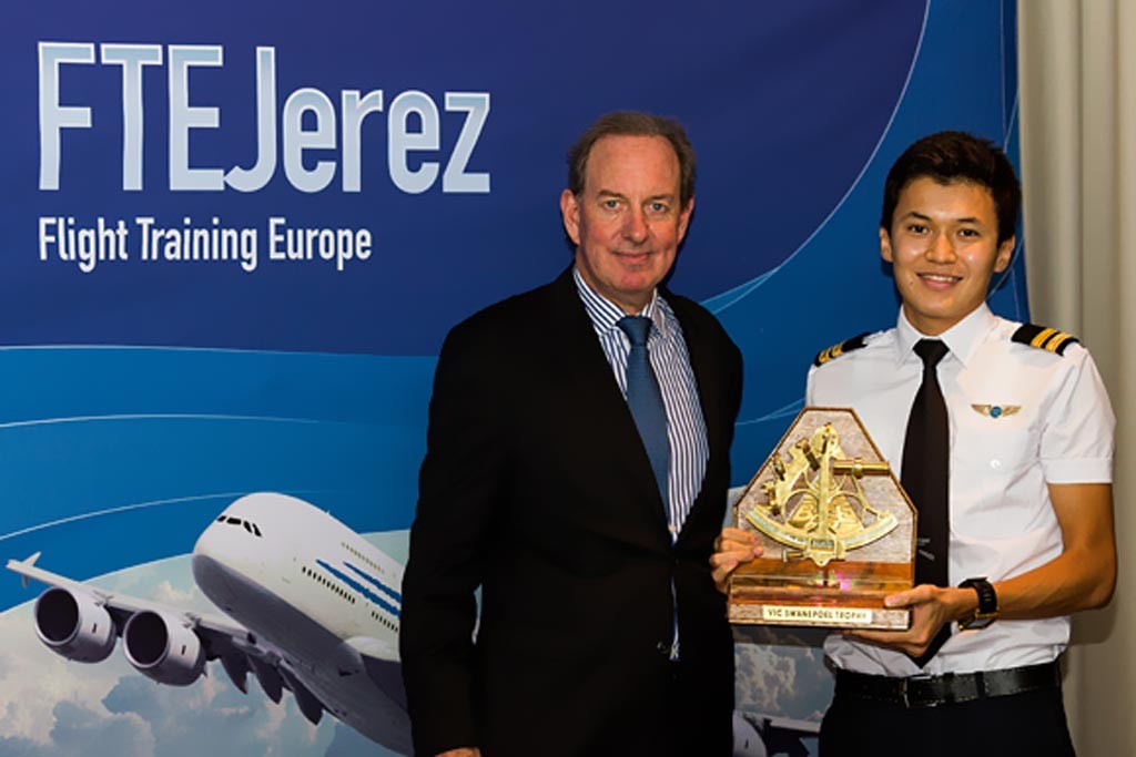 Altynbek Zeinelov receiving the Vic Swanepoel trophy from Mr. Peter Foster, President of Air Astana.